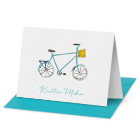 Folded Note Card featuring a bicycle printed on white paper.
